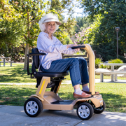 woman riding the Reyhee Flex (RF01) Electric Folding Mobility Scooter in Tan